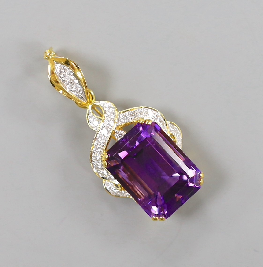 A modern yellow metal, emerald cut amethyst and diamond cluster set drop pendant, 45mm, gross weight 13.5 grams.